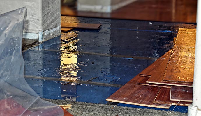 water damage to floor with water removal equipment