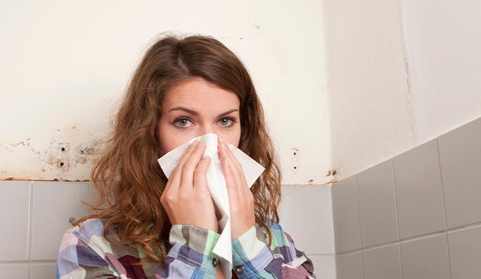 allergy effected woman in front of mold