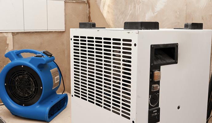 Blue air movers and water damage restoration equipment