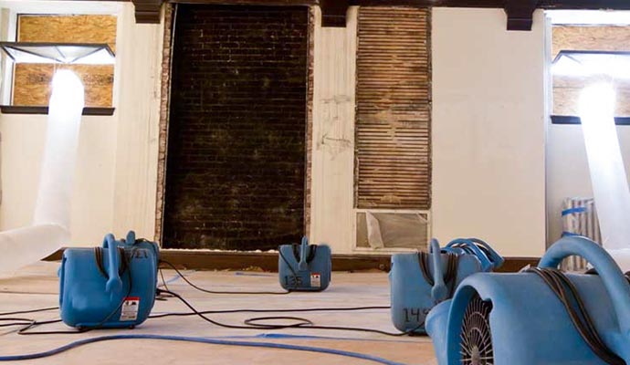 blue air movers poly pipe water damage restoration process